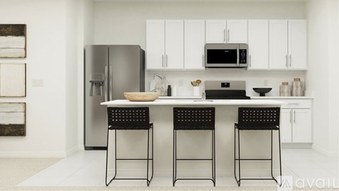 A kitchen with white cabinets and a black table.