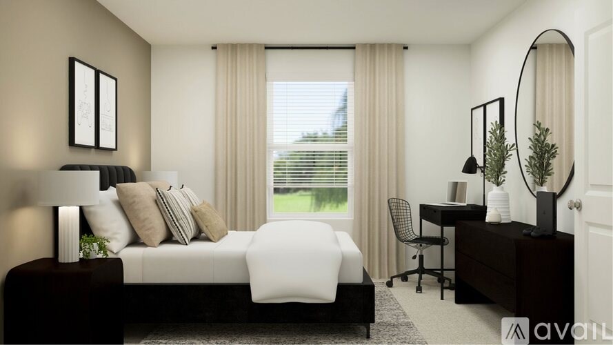 A modern bedroom with a large bed, desk, and chair.