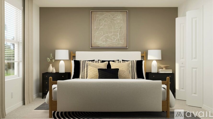 A bedroom with a large bed and two nightstands with lamps.