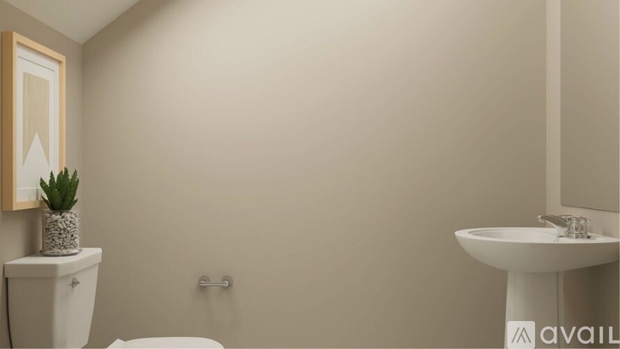 A bathroom with a toilet, sink, and mirror.