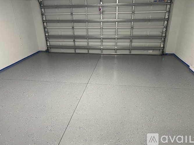 A spacious garage with a closed metal shelving unit.