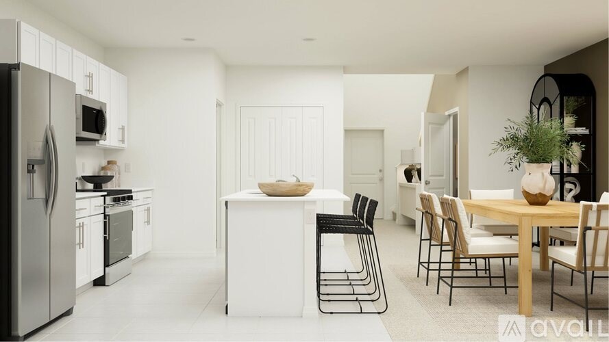 A modern kitchen with a dining table set for four.