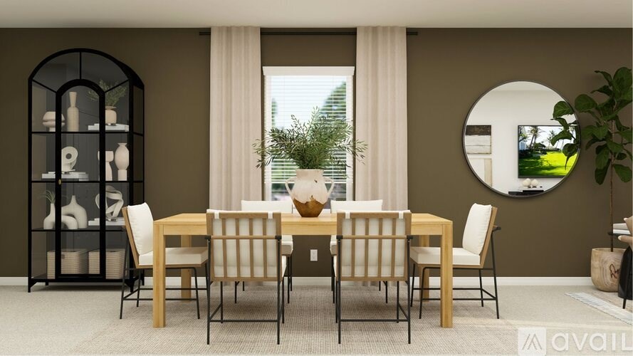 A dining room with a table set for six and a round mirror on the wall.