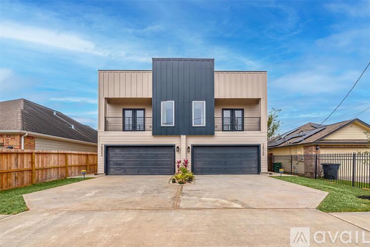 A modern two-story house with a garage is for sale.