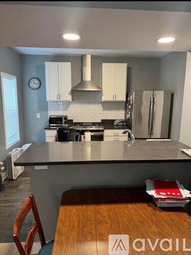 A kitchen with a stove, oven, and refrigerator.