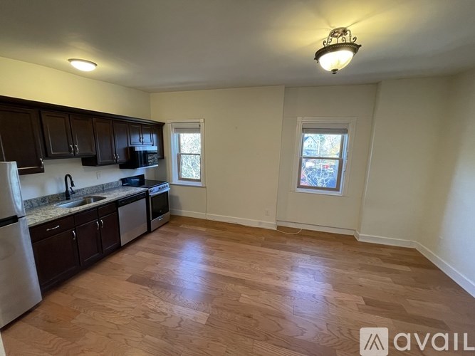 A kitchen with wooden floors and white walls.