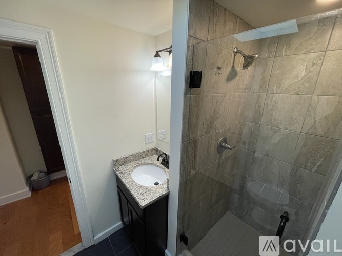 A bathroom with a sink and a shower.