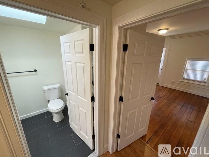 A bathroom with a toilet and a door.