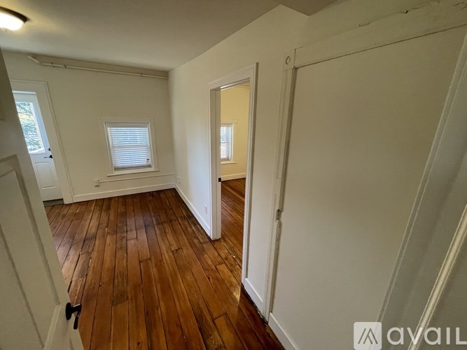 A room with wooden floors and white walls.