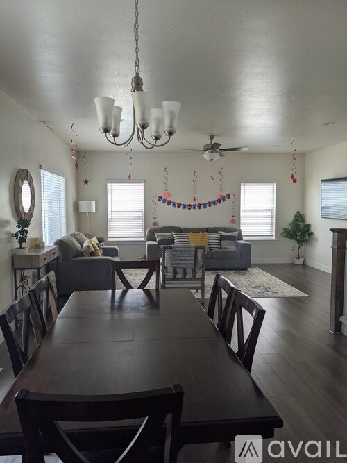 A dining room with a long table and chairs.