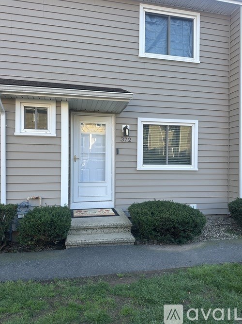 A patio with a table and chairs is covered with a black tarp.