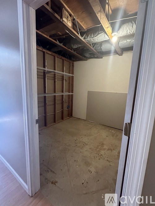 A room with a door open to a construction site.