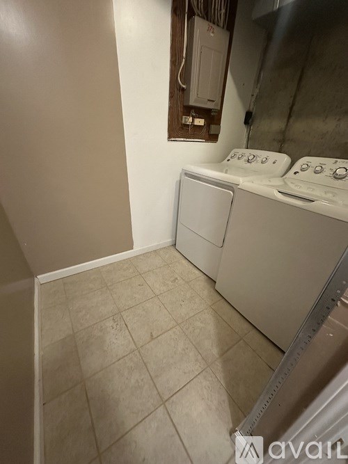A small laundry room with a washer and dryer.