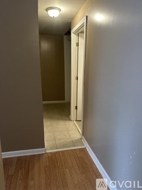 A hallway with a door at the end.