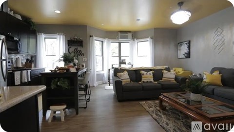 A living room with a grey couch and a coffee table.