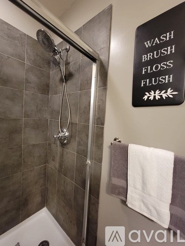 A bathroom with a sign that says "Wash Brush Floss Flush".