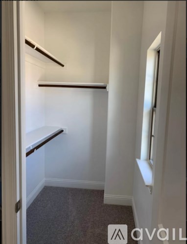 A small, empty room with a window on the right side.