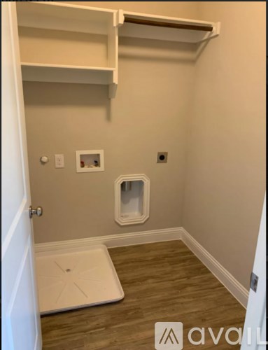 A small bathroom with a toilet and a shelf above it.