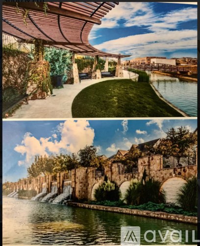 A modern outdoor seating area with a water feature and a stone bridge.