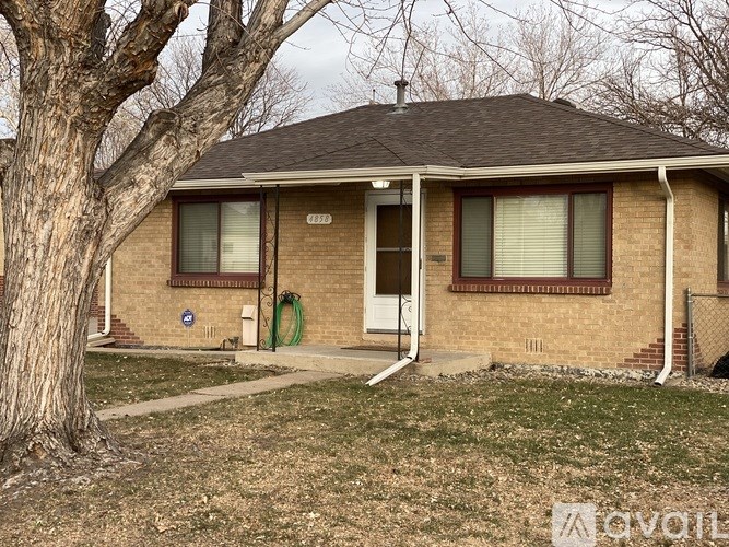 A house with a tree in front of it.