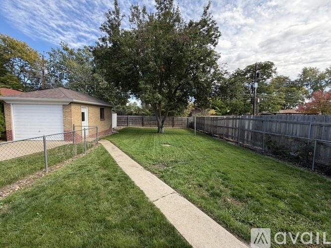 A room with wooden flooring and a window with blinds.