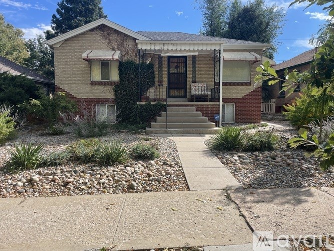 A house with a front yard and a driveway.