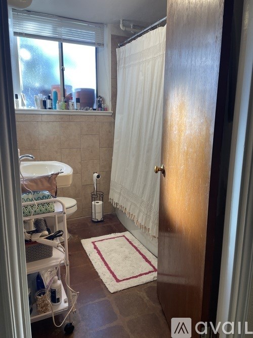 A room with a window and a light on the ceiling.