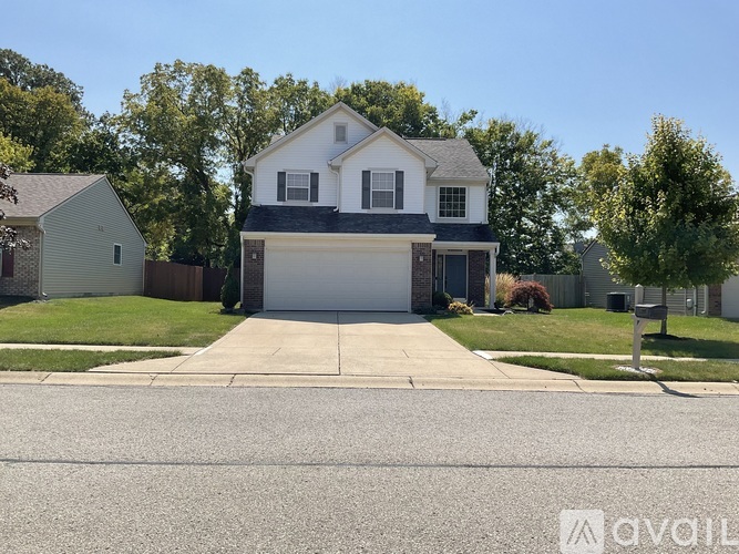 A two-story house with a garage is for sale.