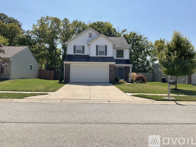 A two-story house with a garage is for sale.