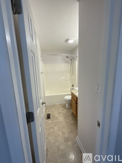 A bathroom with a toilet, sink, and shower.