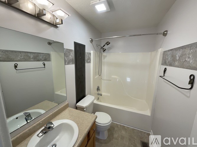 A bathroom with a toilet, sink, and bathtub.