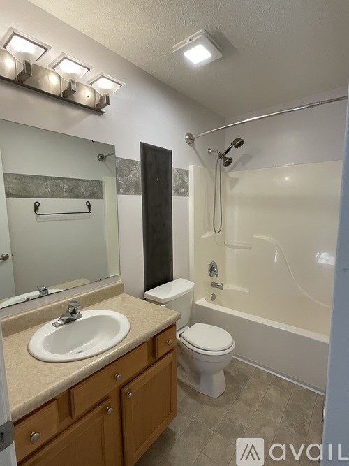 A bathroom with a sink, toilet, and bathtub.