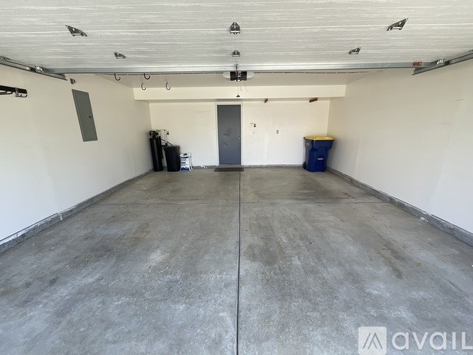 A large empty room with a concrete floor and white walls.