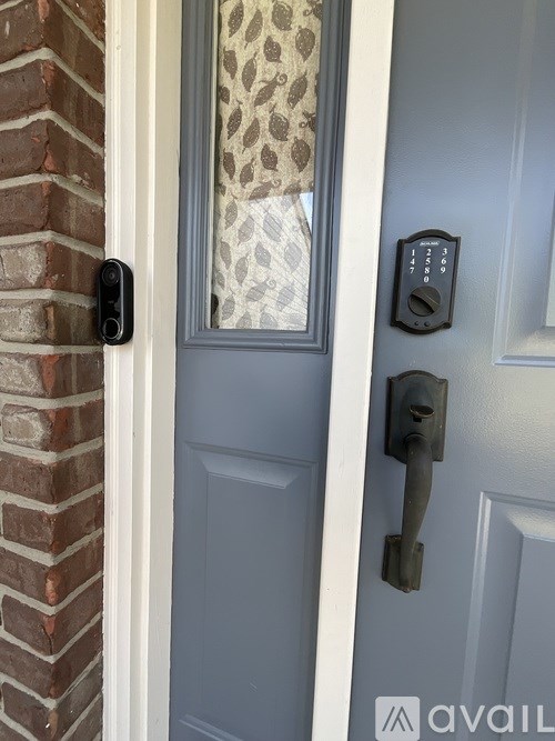 A door with a handle and a lock with a keypad.