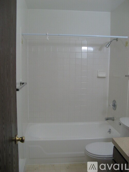 A bathroom with a toilet, tub, and sink.