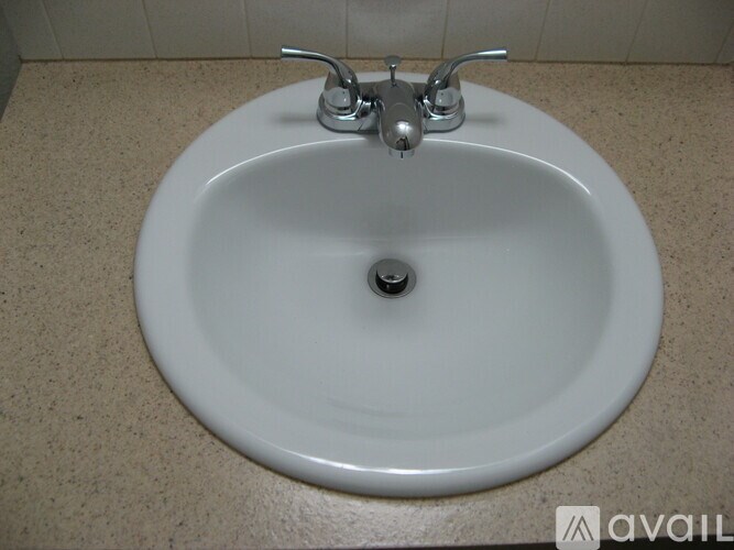 A white sink with chrome faucet and a single drain.