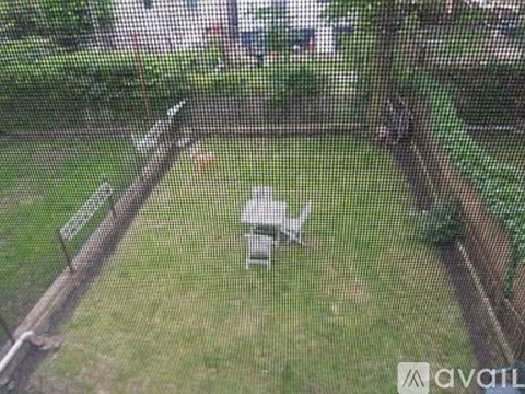 A small white airplane is parked in a grassy field.