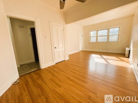 A room with wooden floors and white walls.