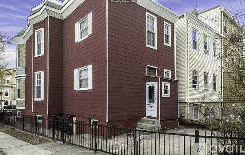 A red brick house with a white door and windows.