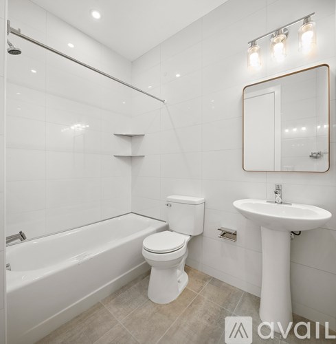 A white bathroom with a toilet, sink, and bathtub.