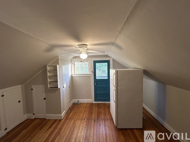 A room with wooden floors and a ceiling fan.