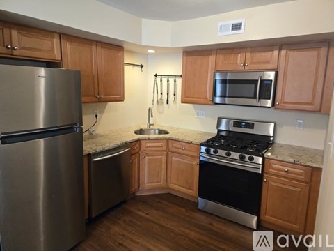 A kitchen with wooden cabinets and stainless steel appliances.