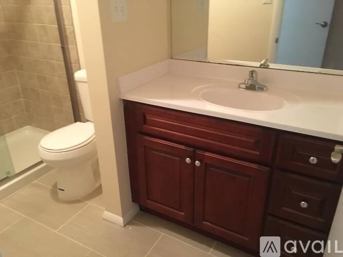 A white toilet sits next to a sink in a bathroom.