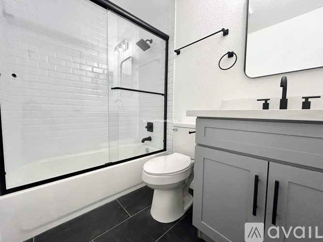 A white toilet in a bathroom with a glass shower door.