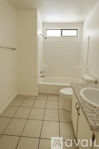 A white bathroom with a toilet, sink, and bathtub.