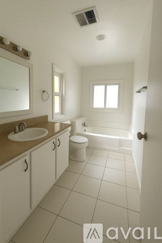 A bathroom with a toilet, sink, and bathtub.