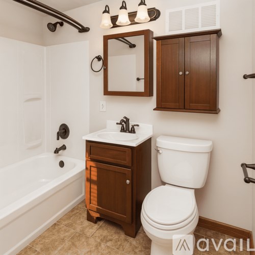 A white toilet sits next to a sink in a bathroom.