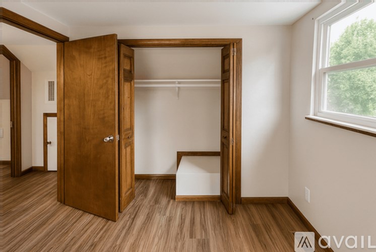 A room with a wooden floor and a large open door.