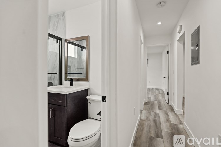 A bathroom with a toilet and a mirror.