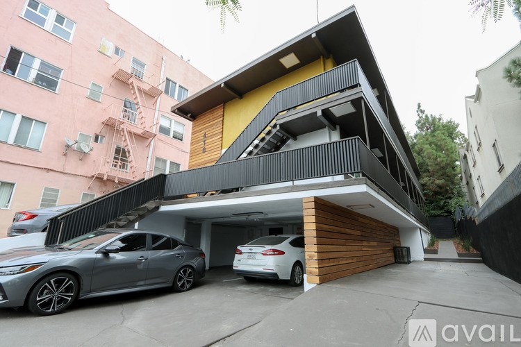 A modern two-story house with a garage and a car parked in front.